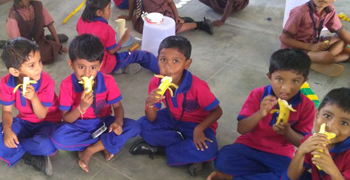 Photo of school boys eating bananas